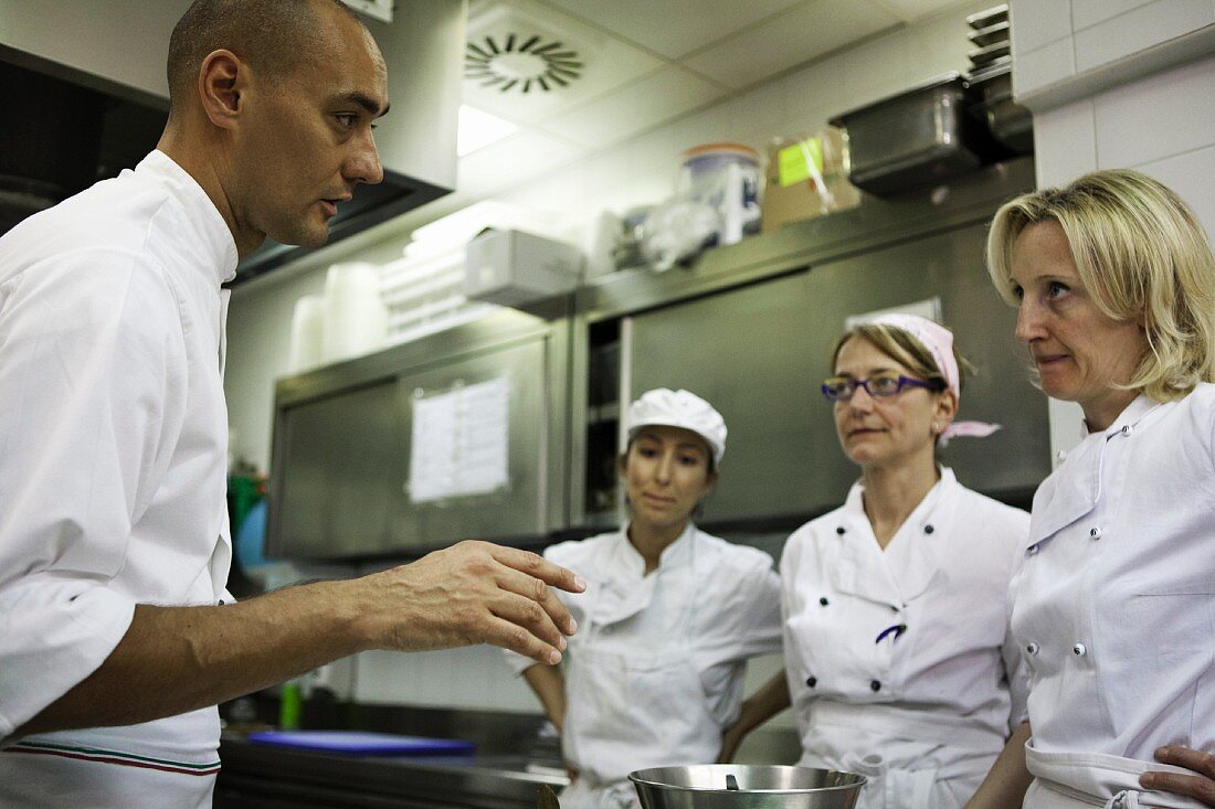 A chef giving staff instructions