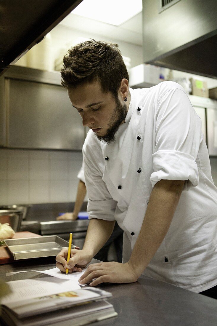 A young chef making notes