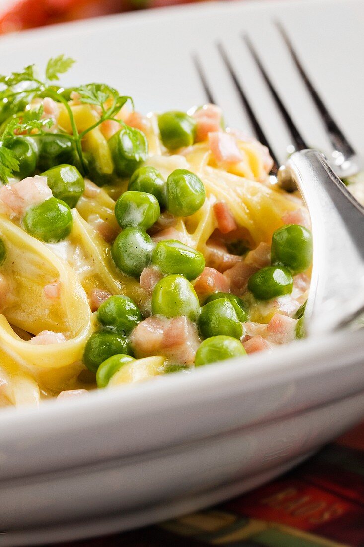 Pasta with Sliced Ham and Peas in a Garlic Butter Sauce; Close Up