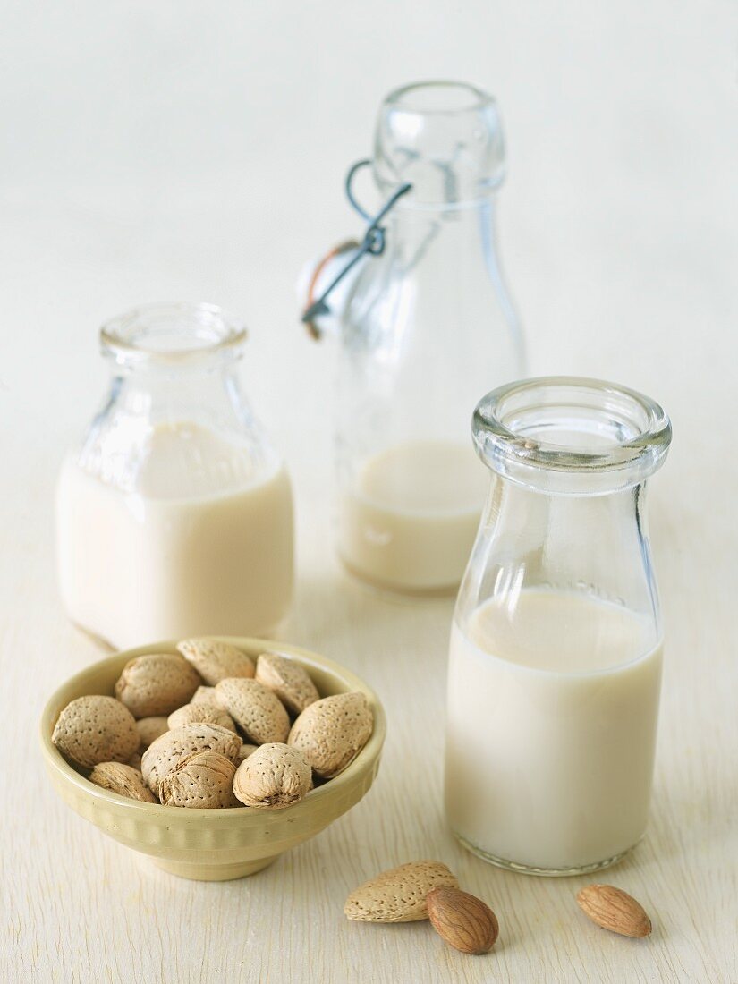 Three Bottles of Almond Milk with Whole Almonds