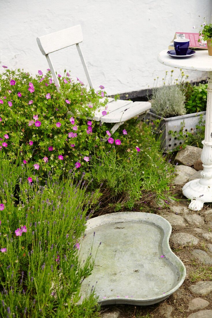 Bird bath next to garden chair