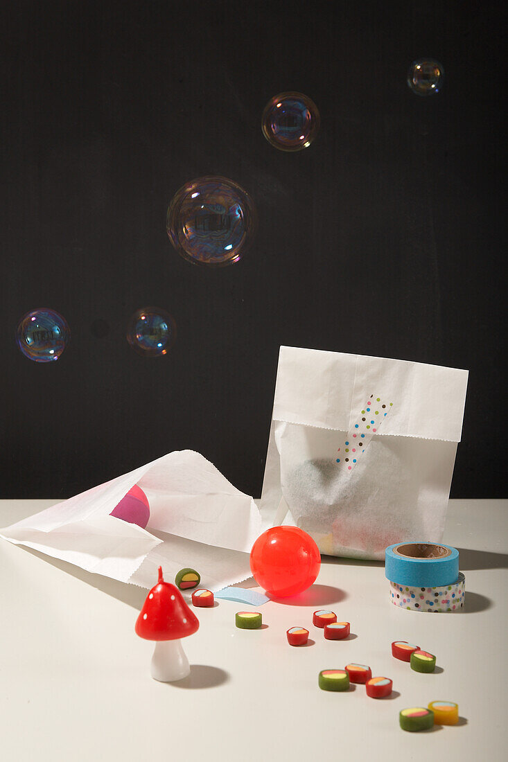 Bubbles over gift bags, decorative toadstool and colorful adhesive tape