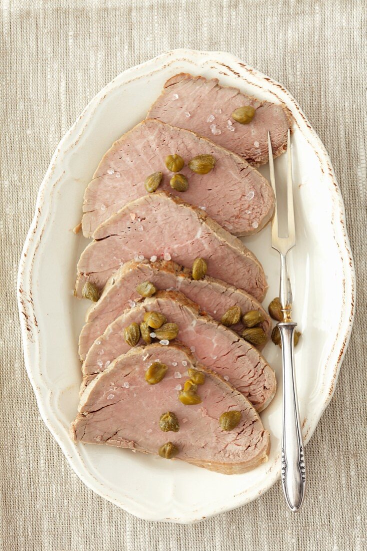 Sliced of roast beef with capers