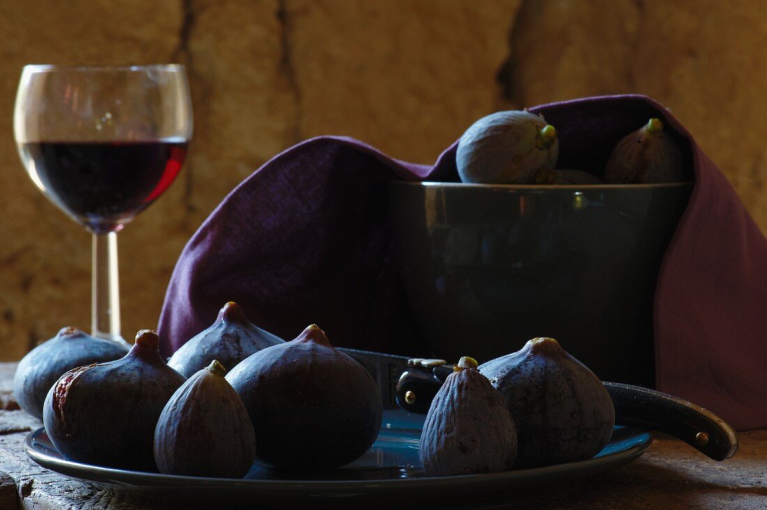 Still-life with fogs, glass of red wind and Laguiole knife