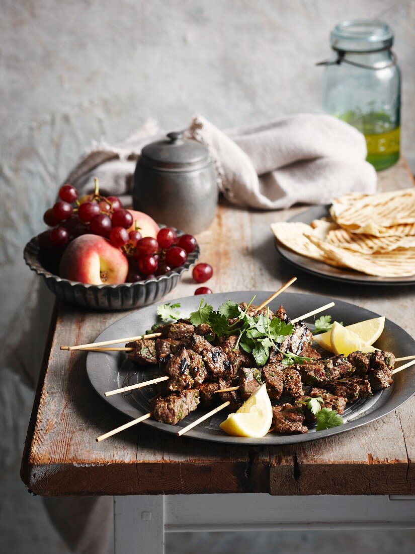 Beef kebabs with coriander on a rustic table
