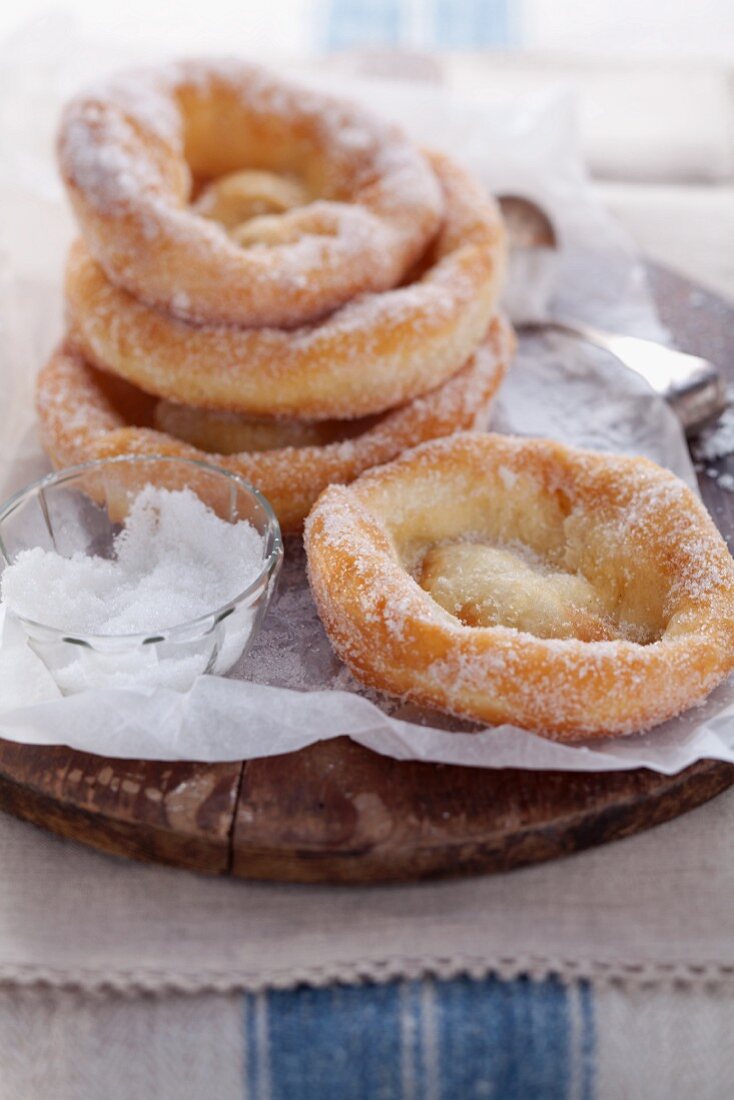 Bavarian-style doughnuts with sugar on baking paper