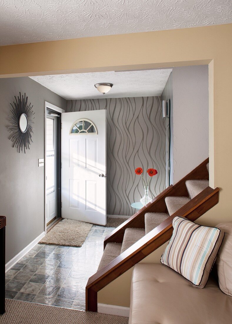 Foot of staircase leading from foyer in natural shades