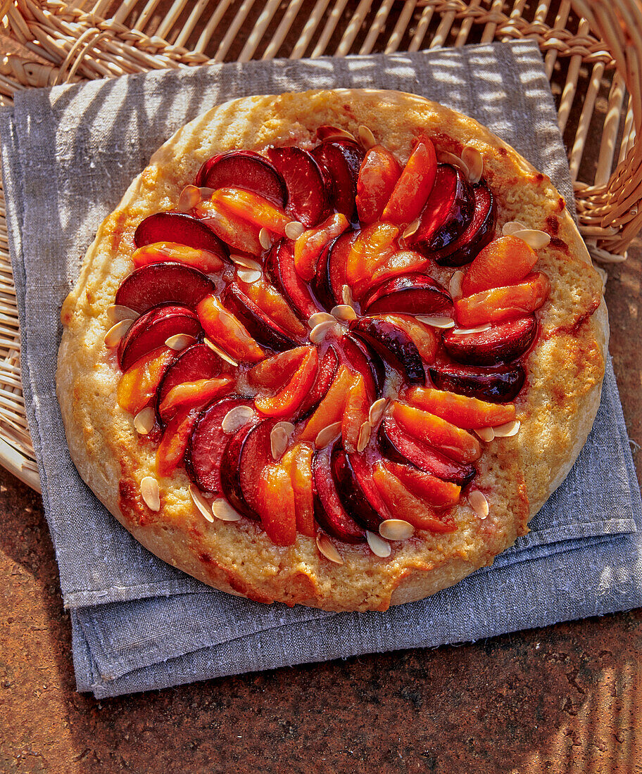 A fruit pizza with slivered almonds