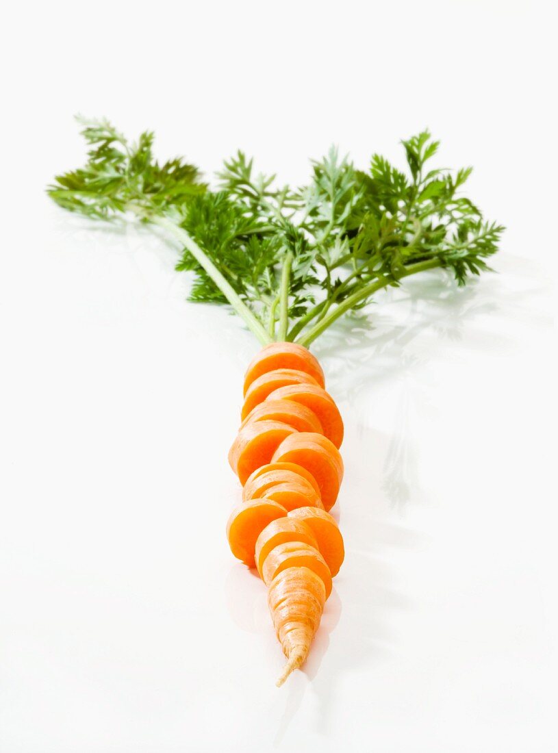 A sliced carrot with leaves