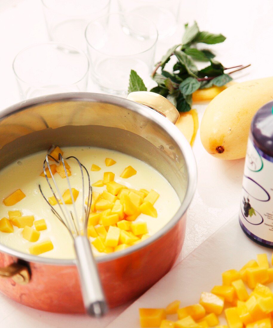 Mango pudding with mint being prepared