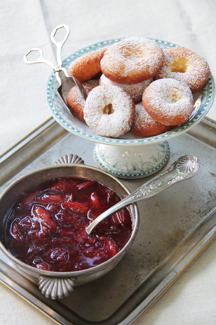 Ausgezogene (Bavarian-style doughnuts) and damson compote on a silver tray