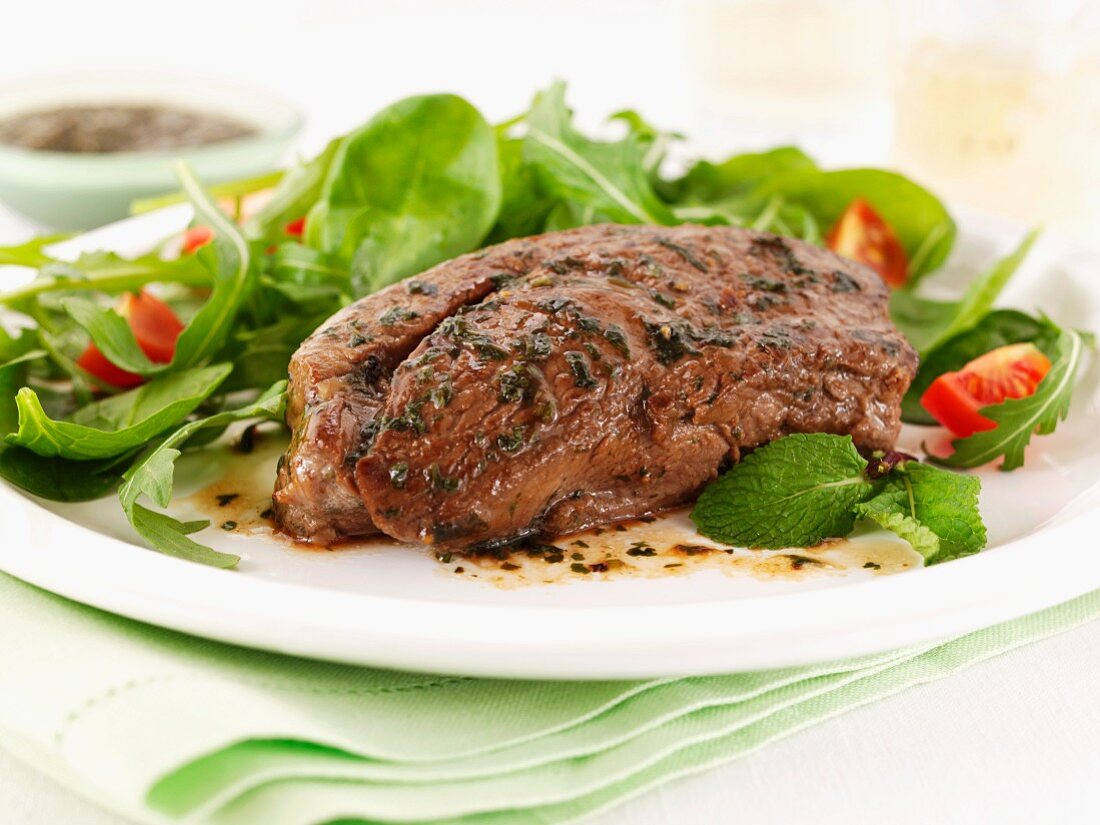 Lamb steak with mint and salad