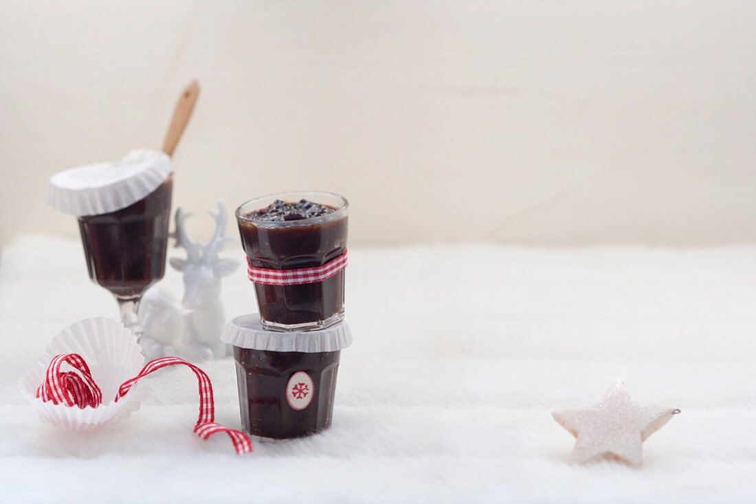 Plum sauce in jars in wintry surroundings