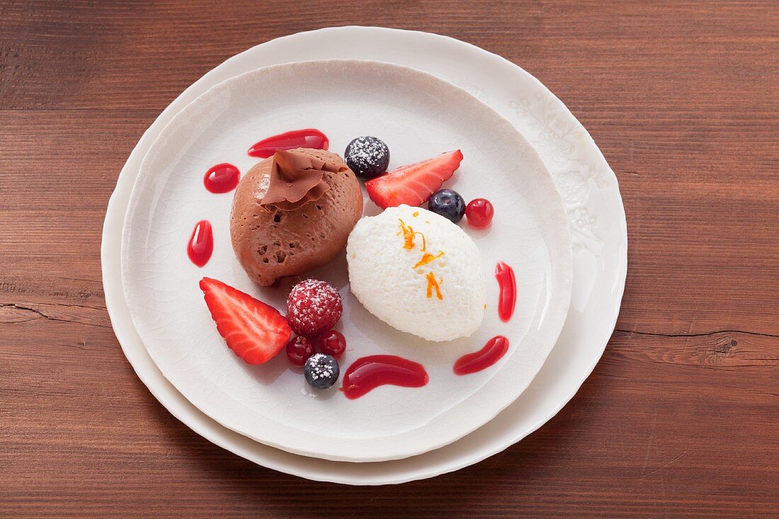 Light and dark mousse au chocolat with berry sauce