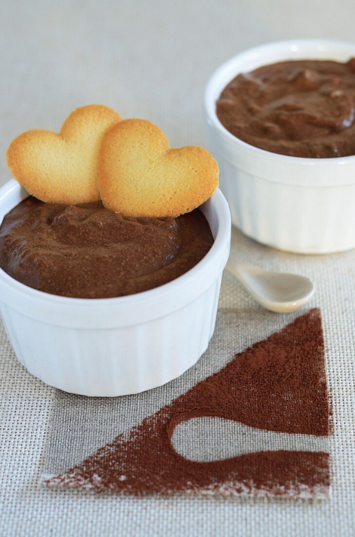 Chocolate pudding with heart-shaped biscuits