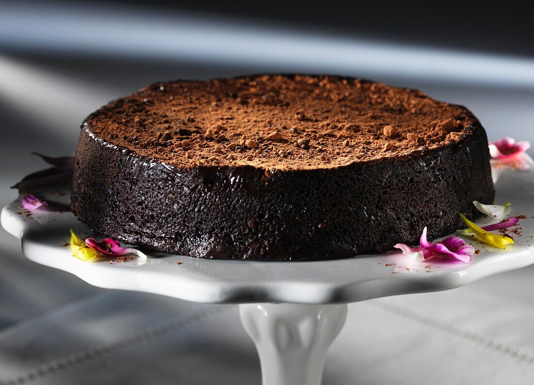 A chocolate truffle cake on a cake stand