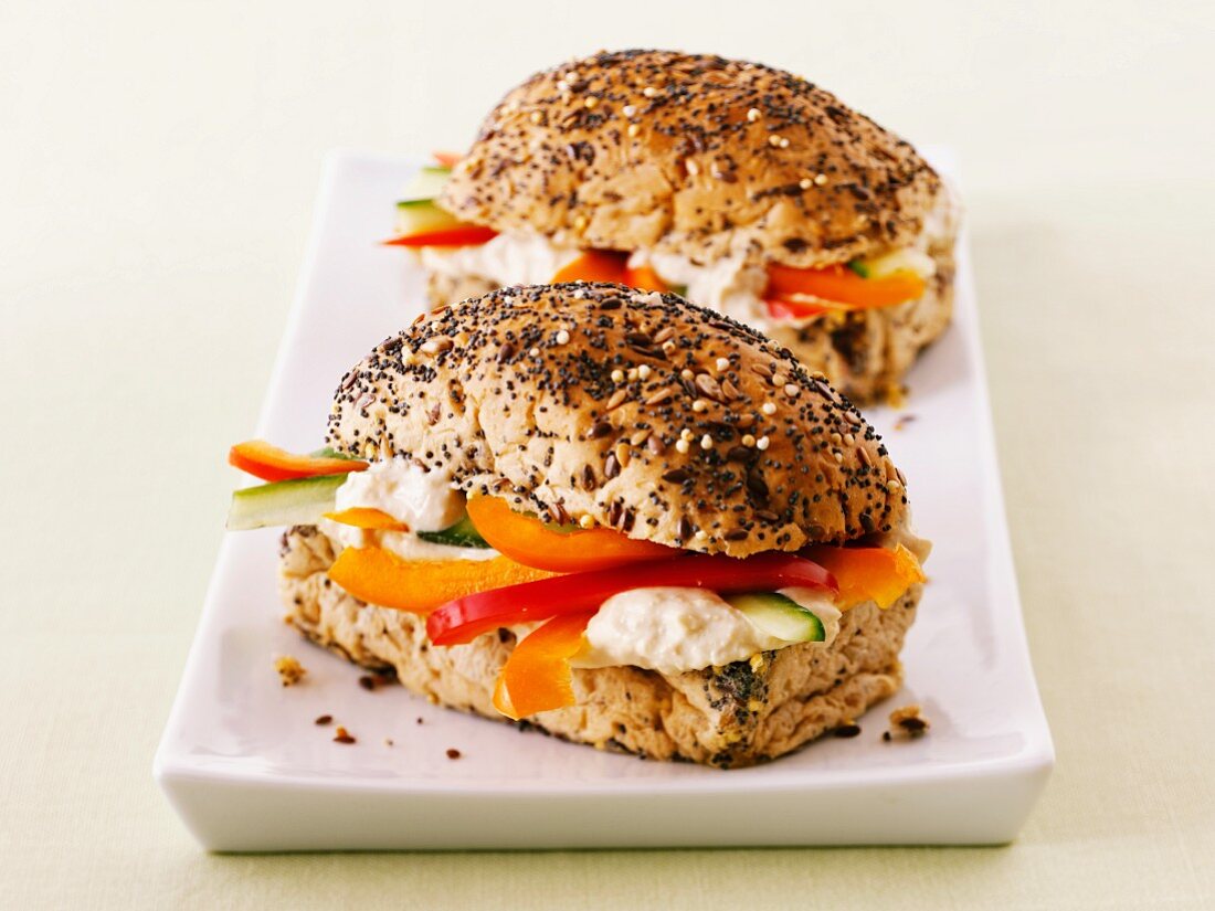 Poppyseed rolls filled with hummus and pepper