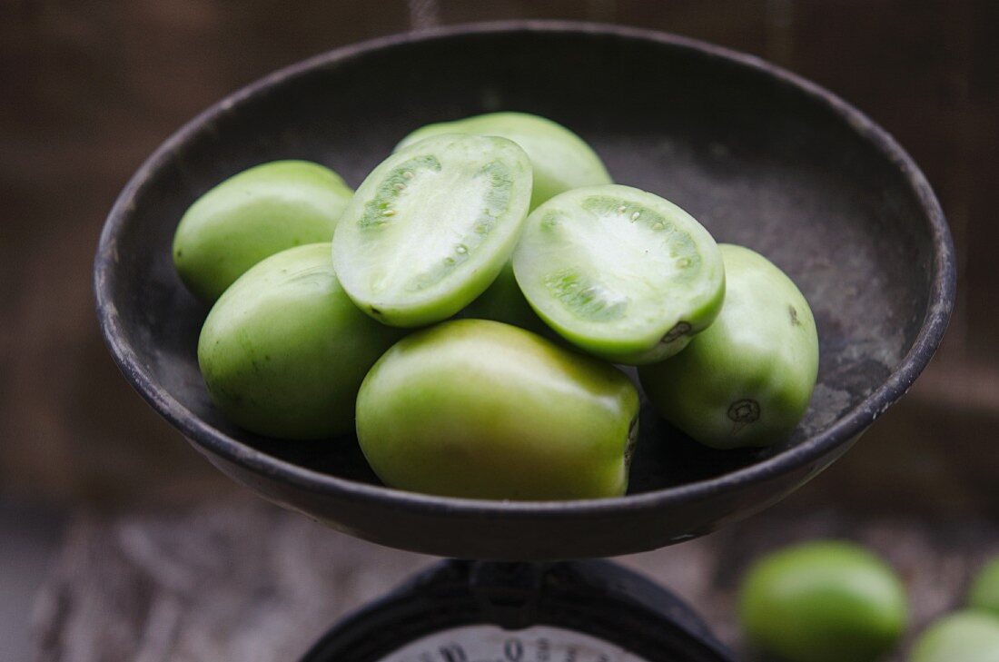 Green tomatoes in an antique scales