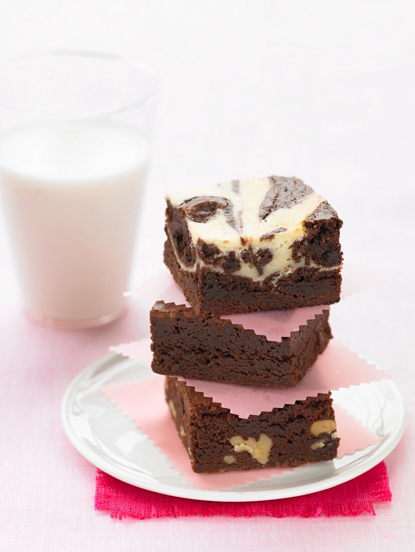A stack of brownies and a glass of milk