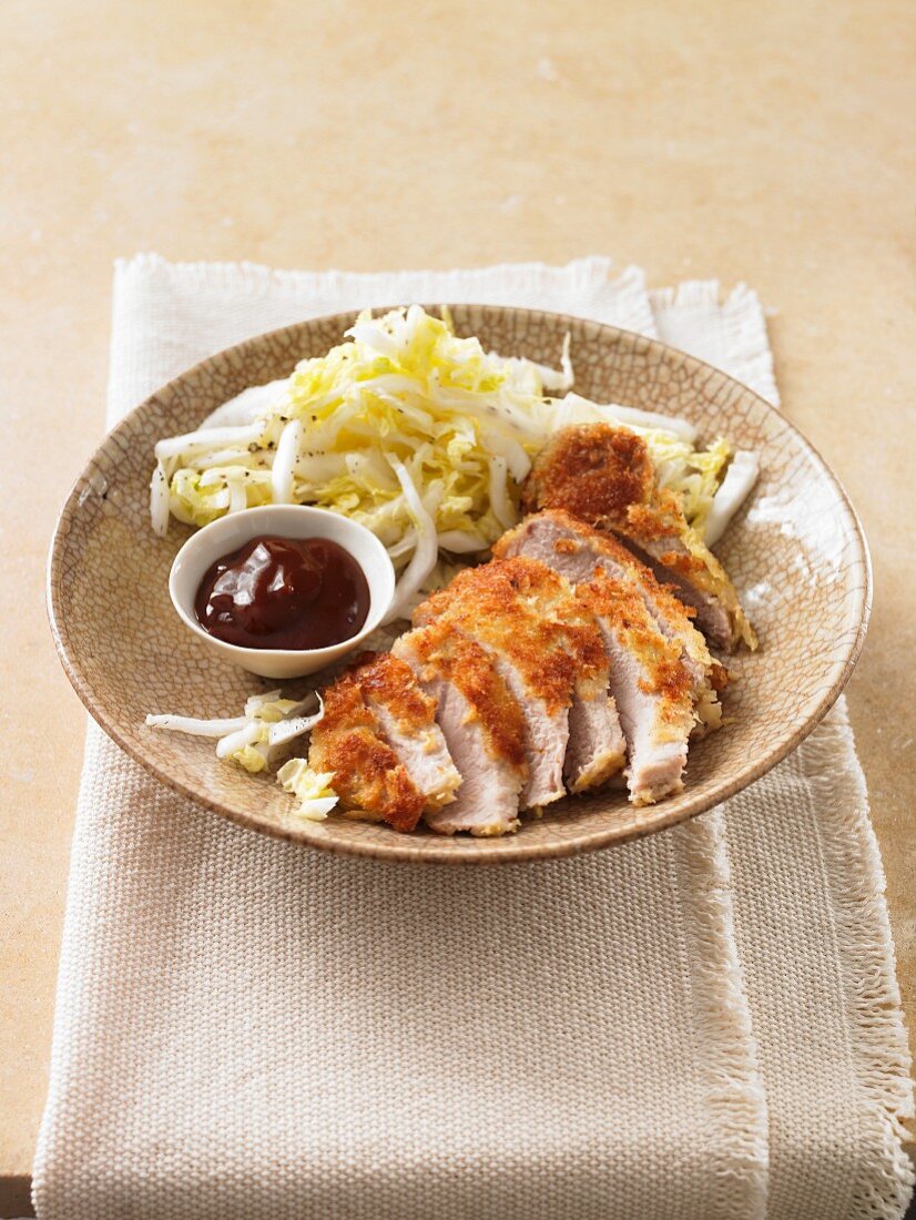 Breaded chicken breast with cabbage salad and barbecue sauce