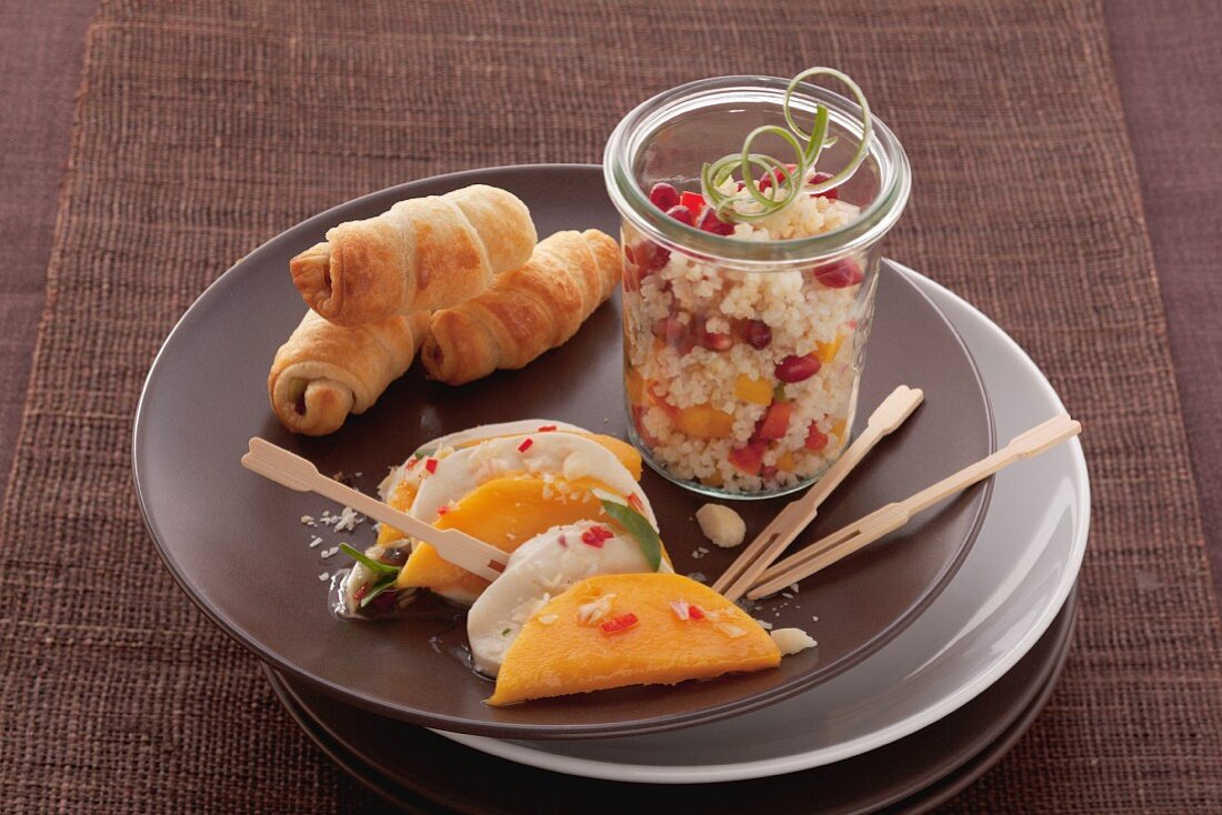 Mango with mozzarella, spicy filled croissants and millet salad