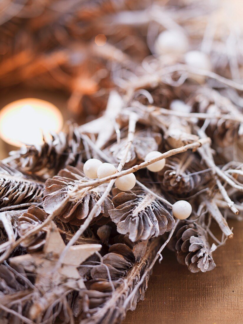 Advent wreath made from pine cones and snowberries