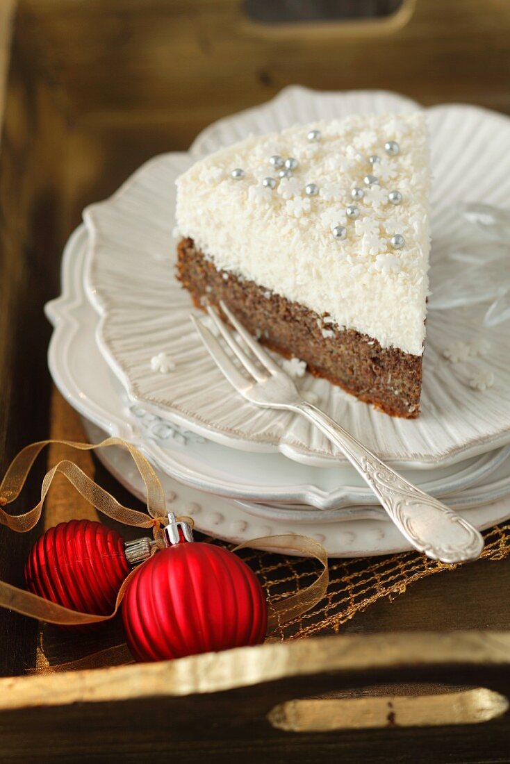 A slice of poppy seed cake with coconut mousse for Christmas