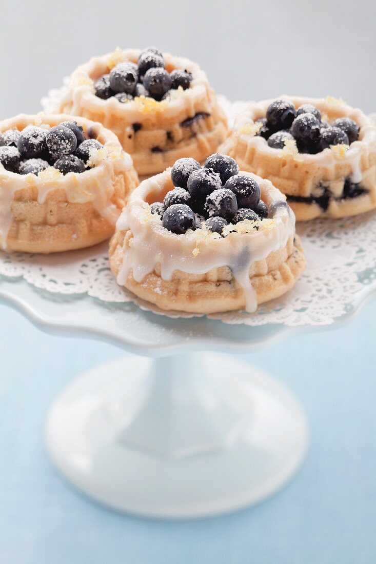 Mini blueberry tarts on a cake stand