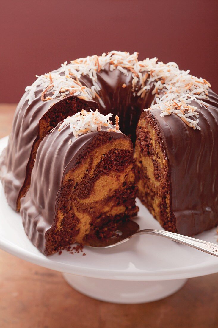 Marble cake with chocolate glaze and grated coconut