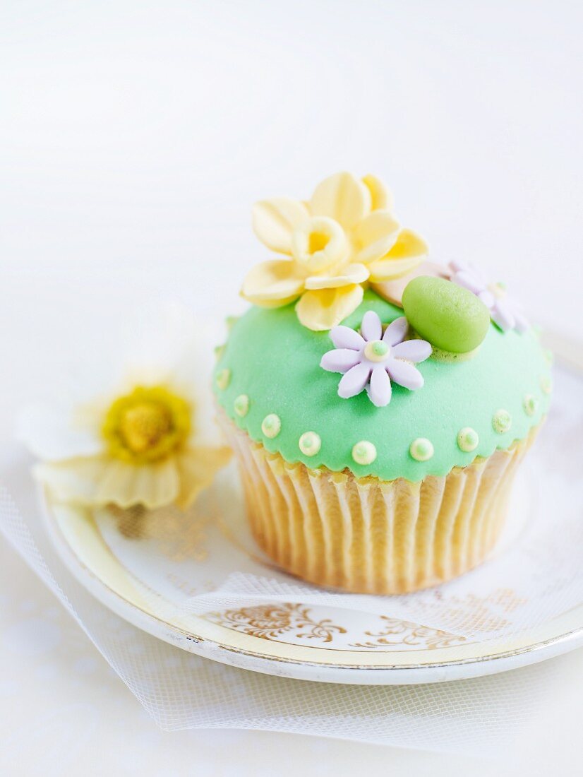 Cupcake mit grünem Zuckerguss und Marzipandekoration