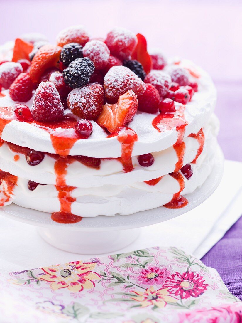 Pavlova with fresh berries on a cake stand