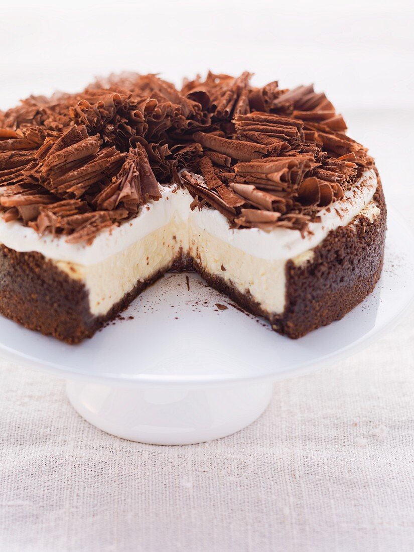 Chocolate cheesecake topped with cream and grated chocolate