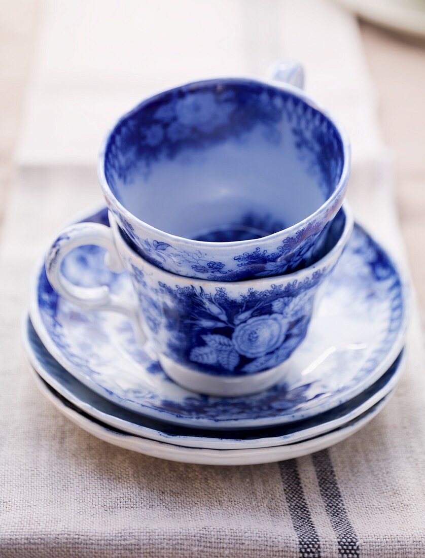 Two blue coffee cups and saucers
