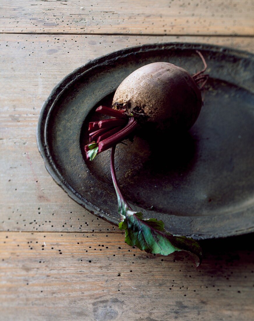 A beetroot on an old metal plate