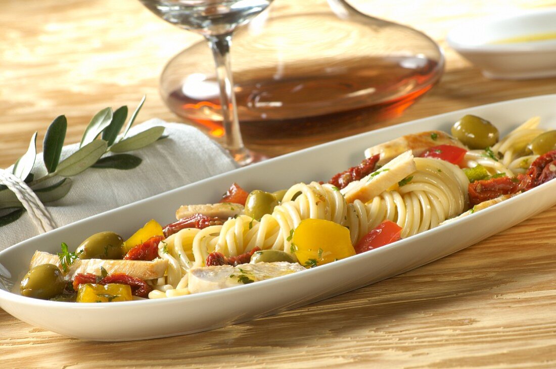 An anti-pasta platter with spaghetti, olives, pepper and chicken