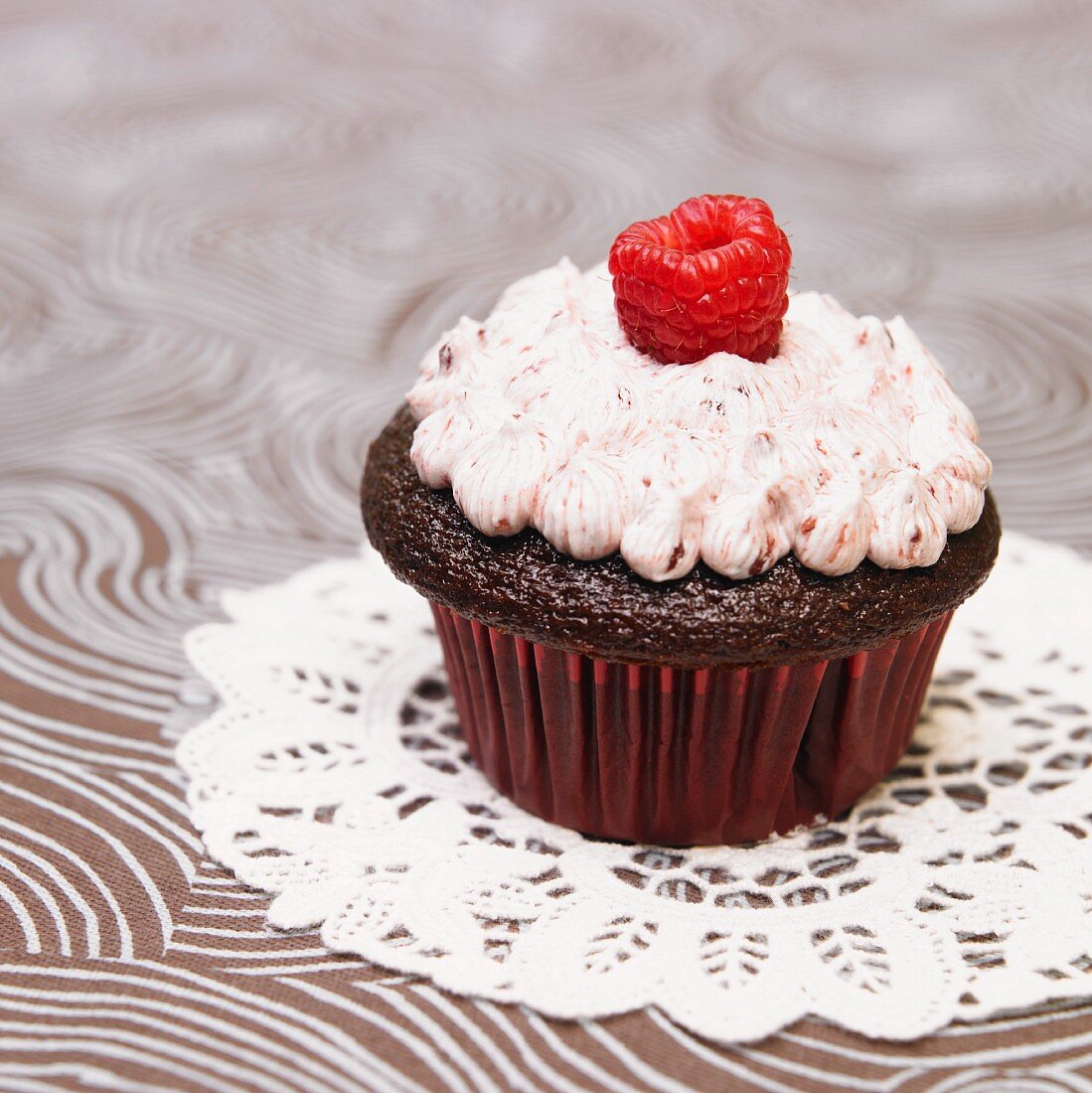Chocolate Cupcake with Raspberry Frosting with a Fresh Raspberry Garnish