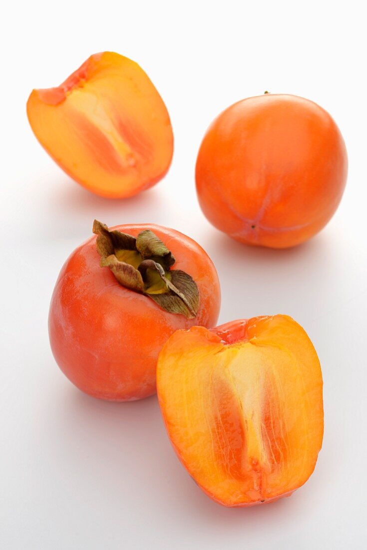 Whole and halved persimmons