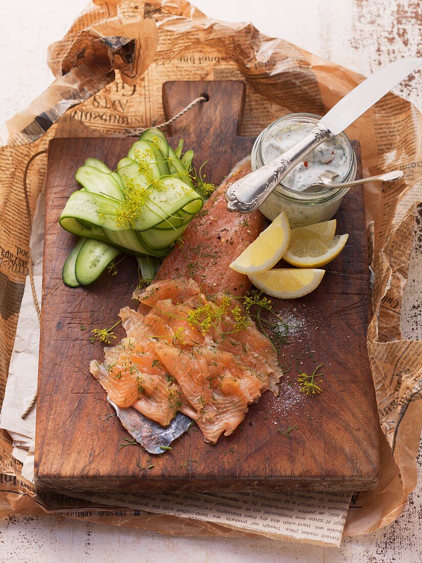 Filleted char with dill flowers, remoulade, sliced cucumber and lemon wedges