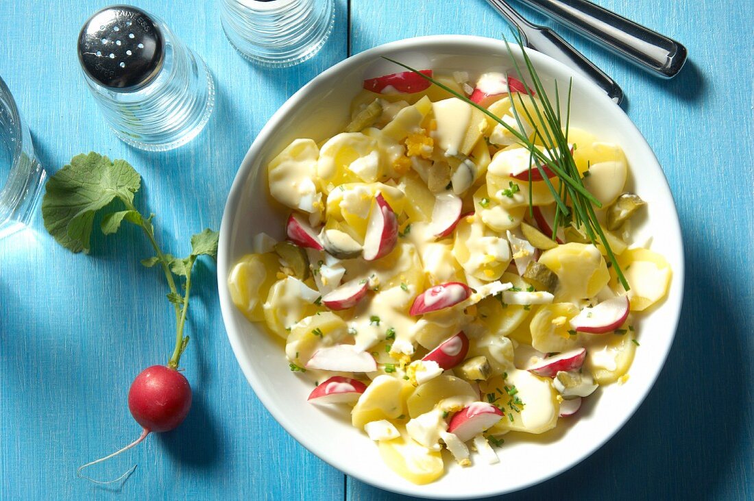 Potato salad with egg, gherkins, onions, radishes and mayonnaise