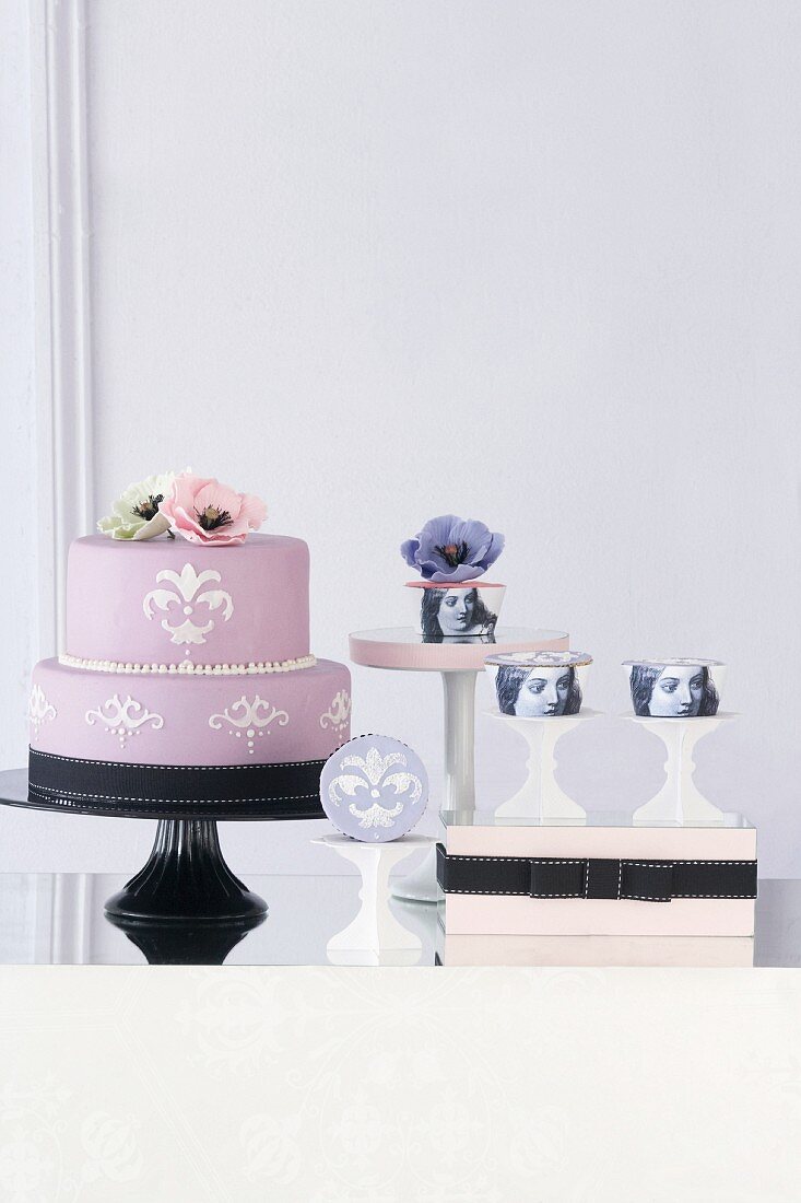 An arrangement of designer cakes and cupcakes