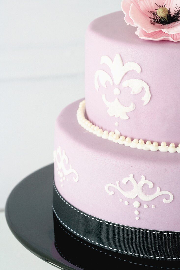 A two-tier lemon cake with stencilled decorations