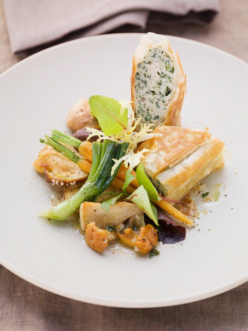 White sausage and herb-filled strudel and a mushrooms salad
