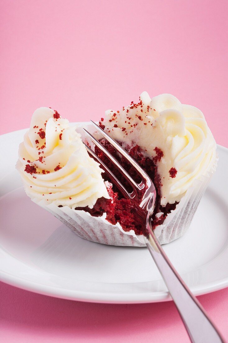 A red velvet cupcake with a fork