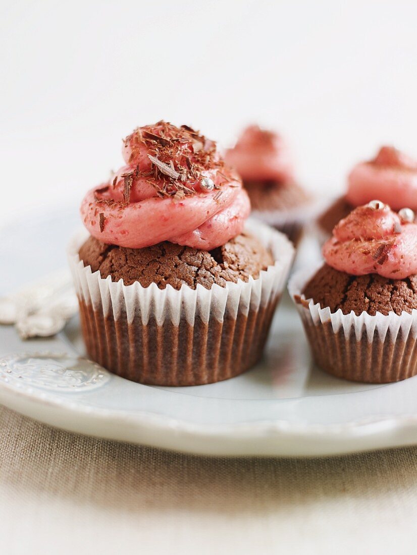 Chocolate cupcakes decorated with raspberry buttercream