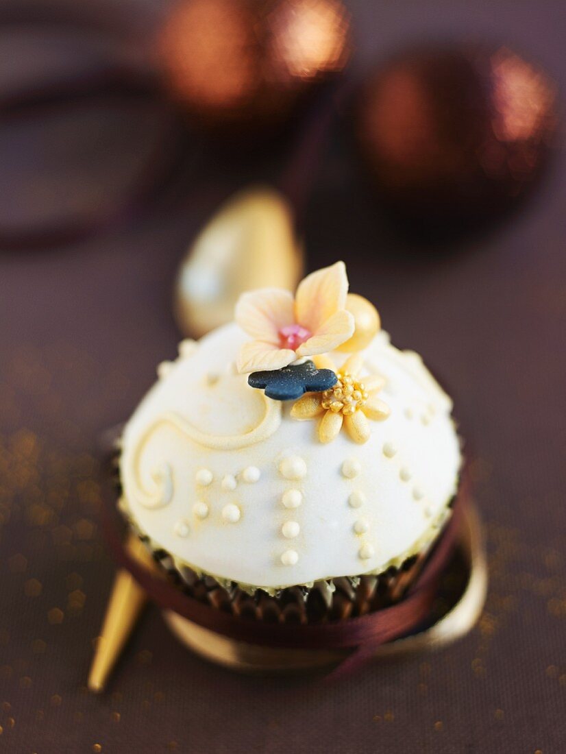 A Christmas cupcake decorated with white icing