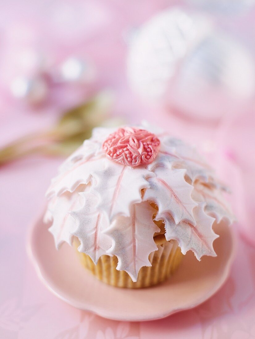 A Christmas cupcake with pink decorations