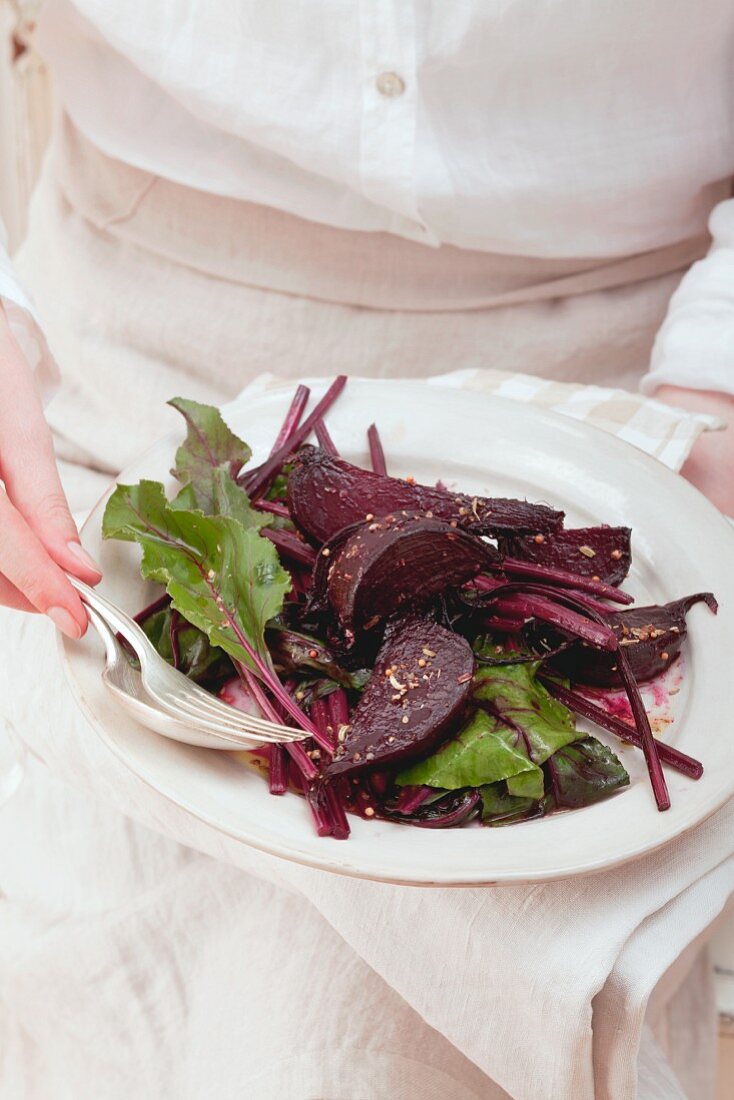 Fried beetroot with leaves on a plate