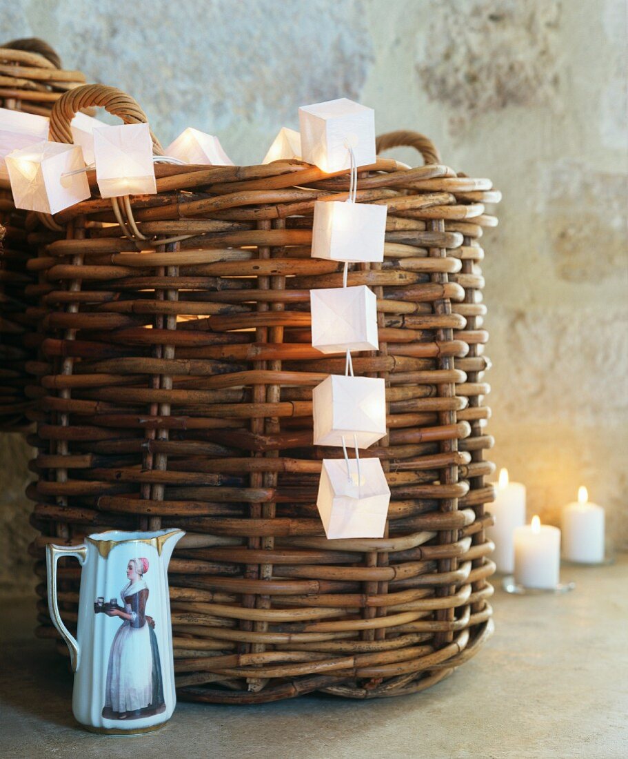 String of fairy lights, wicker basket & small china jug in Château Maignaut (Pyrenees, France)