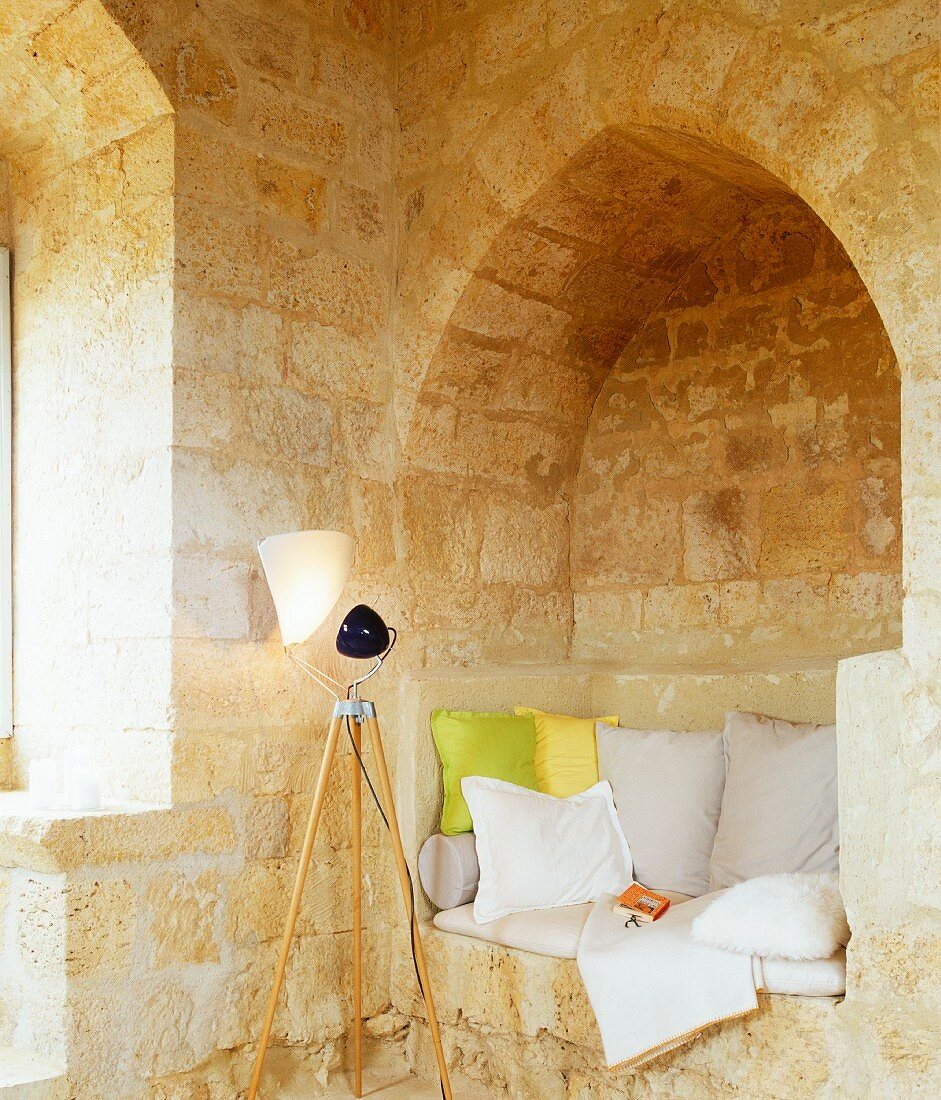 Seat in niche with cushions & standard lamp in Château Maignaut (Pyrenees, France)