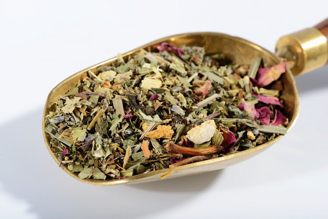 Herbal tea on a brass scoop